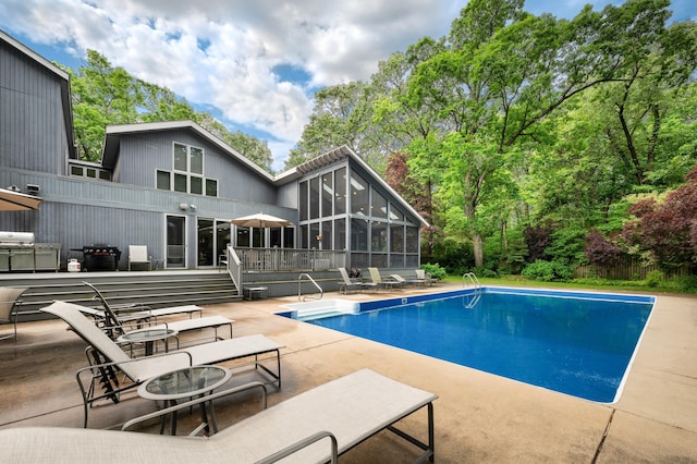 50102 Alpine Blvd, New Buffalo, MI 49117 - outdoor pool with a sunroom, a patio area, and a wooden deck