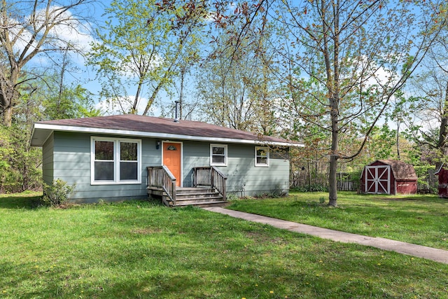 1603 E Detroit St, New Buffalo, MI 49117 - view of front of property featuring a shed, a front lawn, and an outdoor structure