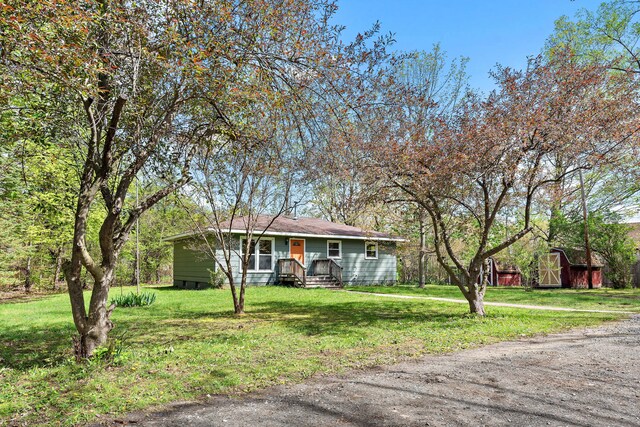 1603 E Detroit St, New Buffalo, MI 49117 - ranch-style house with a storage unit, an outbuilding, and a front lawn