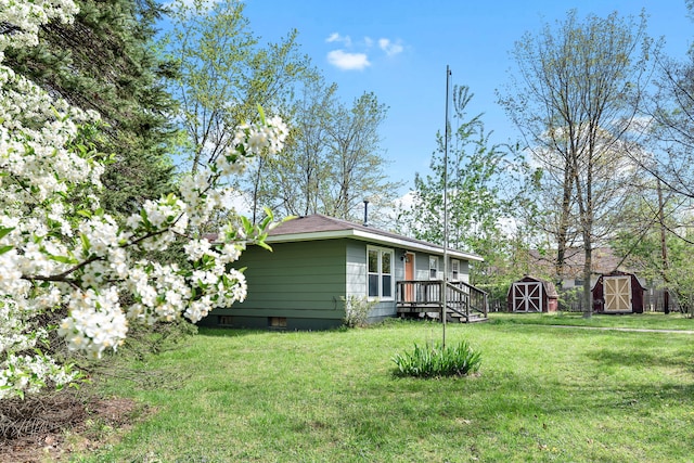 1603 E Detroit St, New Buffalo, MI 49117 - view of property exterior with a shed, an outbuilding, and a yard