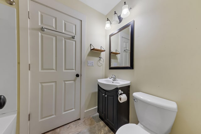 1603 E Detroit St, New Buffalo, MI 49117 - bathroom featuring vanity, toilet, stone finish flooring, and baseboards