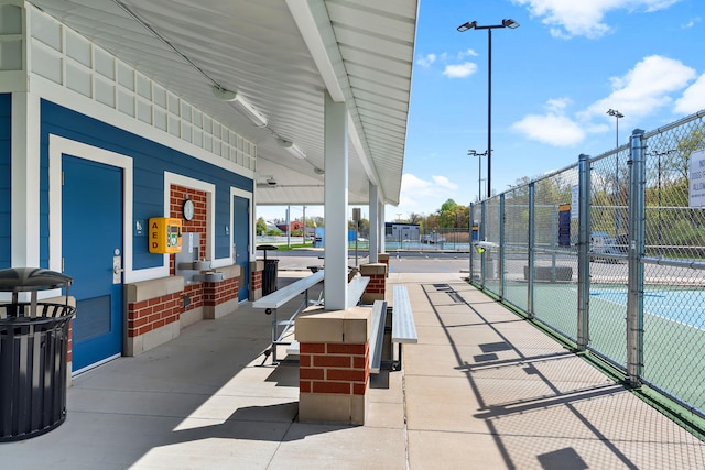 1603 E Detroit St, New Buffalo, MI 49117 - view of patio with fence and a tennis court