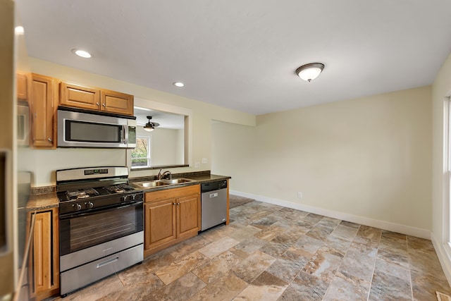 1603 E Detroit St, New Buffalo, MI 49117 - kitchen featuring stainless steel appliances, a sink, dark countertops, light stone finish flooring, and recessed lighting