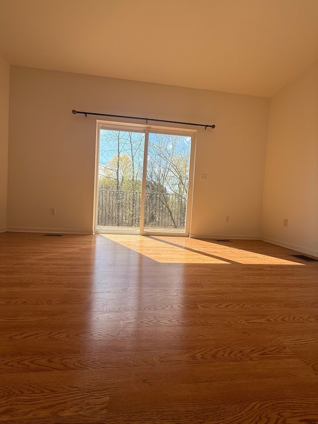 unfurnished room with wood finished floors and baseboards