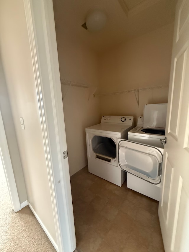 laundry area with washing machine and clothes dryer