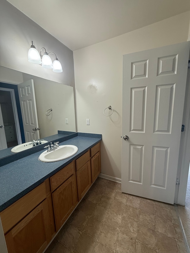 bathroom with vanity and stone finish floors