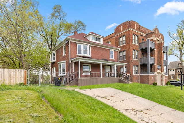 1881 W Grand Blvd, Detroit, MI 48208 - view of front facade featuring a porch, brick siding, and a chimney