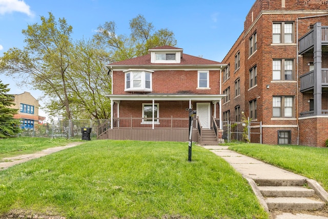 1881 W Grand Blvd, Detroit, MI 48208 - traditional style home featuring a front lawn, covered porch, and brick siding
