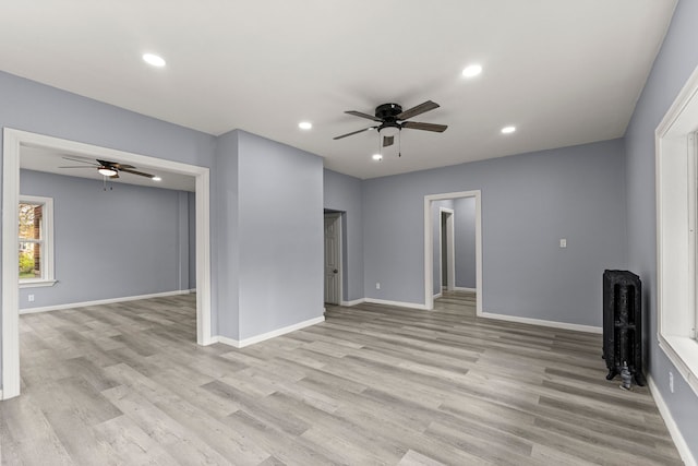 1881 W Grand Blvd, Detroit, MI 48208 - unfurnished living room featuring a ceiling fan, radiator, light wood-style flooring, and recessed lighting