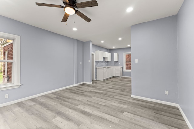 1881 W Grand Blvd, Detroit, MI 48208 - unfurnished living room with baseboards, a ceiling fan, light wood-style floors, recessed lighting, and a sink