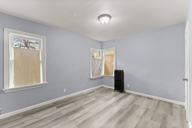 1881 W Grand Blvd, Detroit, MI 48208 - spare room with wood finished floors, healthy amount of natural light, radiator, and baseboards