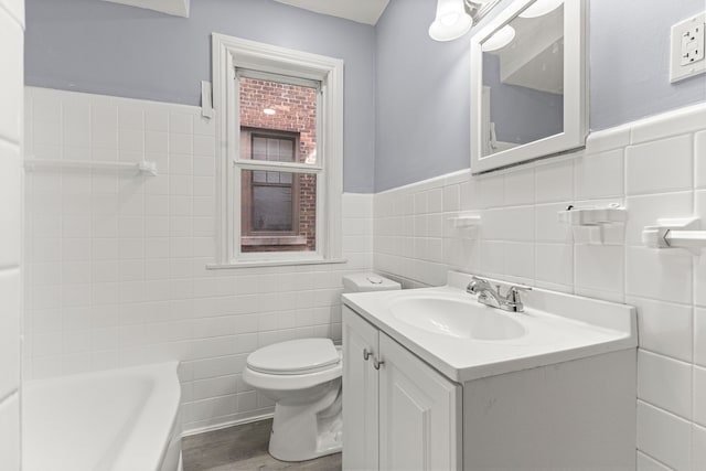 1881 W Grand Blvd, Detroit, MI 48208 - bathroom with tile walls, a tub to relax in, toilet, vanity, and wood finished floors