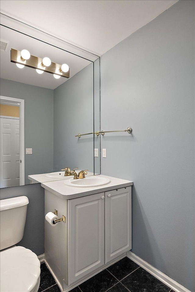 1708 Tremont Rd, Canton, MI 48188 - bathroom with baseboards, vanity, toilet, and tile patterned flooring