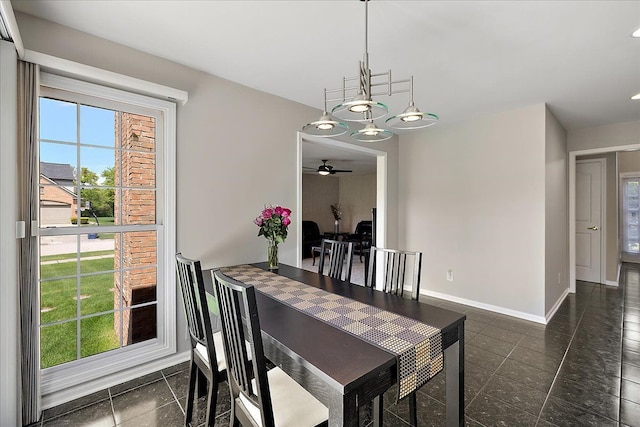 1708 Tremont Rd, Canton, MI 48188 - dining space with baseboards, a ceiling fan, dark tile patterned floors, and a chandelier