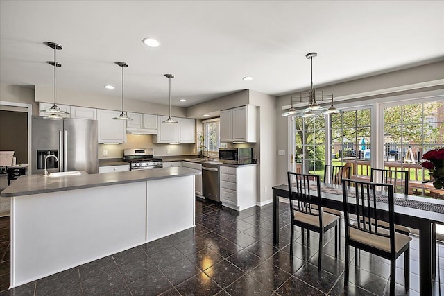 1708 Tremont Rd, Canton, MI 48188 - kitchen with appliances with stainless steel finishes, under cabinet range hood, a sink, dark countertops, and recessed lighting