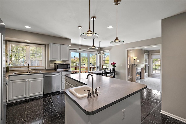 1708 Tremont Rd, Canton, MI 48188 - kitchen featuring appliances with stainless steel finishes, a sink, baseboards, recessed lighting, and dark countertops