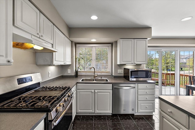 1708 Tremont Rd, Canton, MI 48188 - kitchen featuring appliances with stainless steel finishes, a sink, under cabinet range hood, recessed lighting, and dark countertops