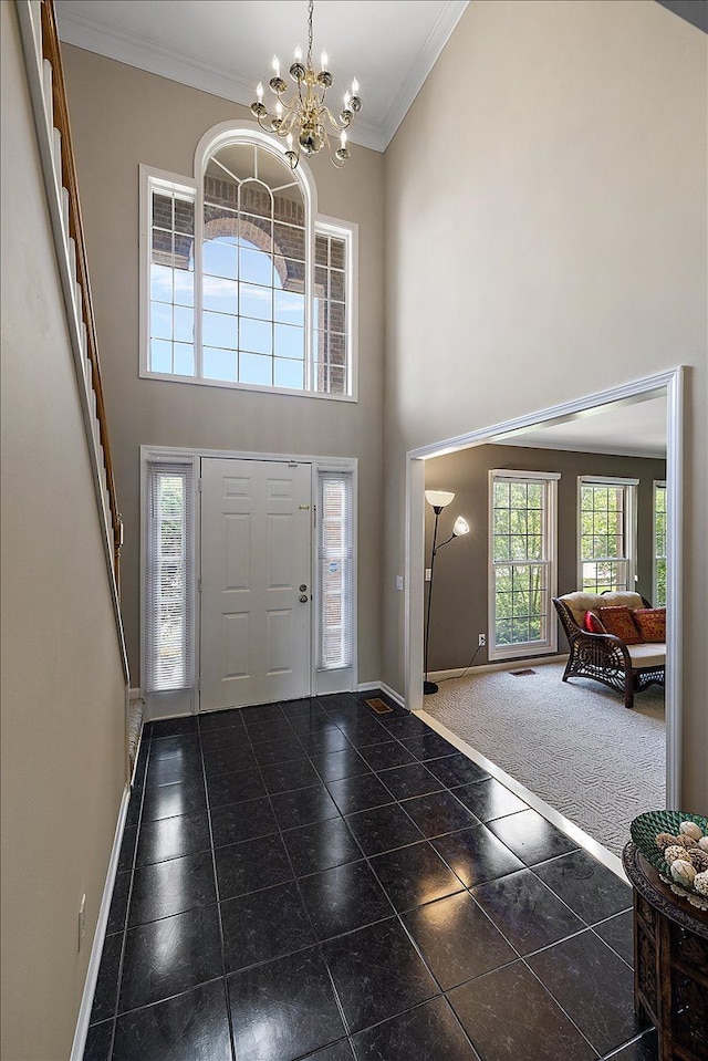 1708 Tremont Rd, Canton, MI 48188 - entrance foyer with crown molding, baseboards, a chandelier, and a towering ceiling