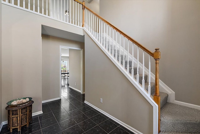 1708 Tremont Rd, Canton, MI 48188 - staircase featuring tile patterned flooring, baseboards, and a towering ceiling
