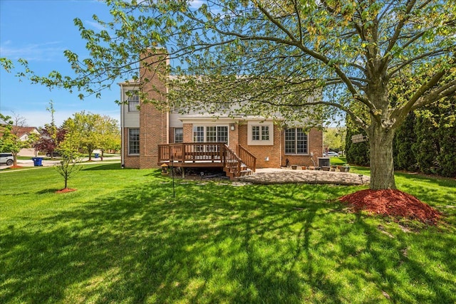 1708 Tremont Rd, Canton, MI 48188 - rear view of house featuring brick siding, a wooden deck, a chimney, a lawn, and a patio area