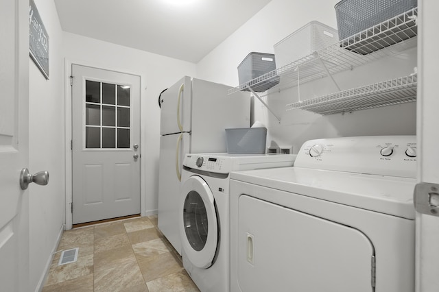4143 Wild Meadow St, Kalamazoo, MI 49048 - laundry area featuring washer and dryer, stone finish floors, and baseboards