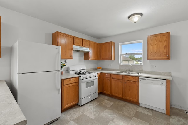 4143 Wild Meadow St, Kalamazoo, MI 49048 - kitchen with white appliances, a sink, under cabinet range hood, light countertops, and stone finish floors