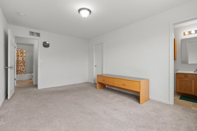4143 Wild Meadow St, Kalamazoo, MI 49048 - unfurnished bedroom featuring light carpet, ensuite bath, and baseboards