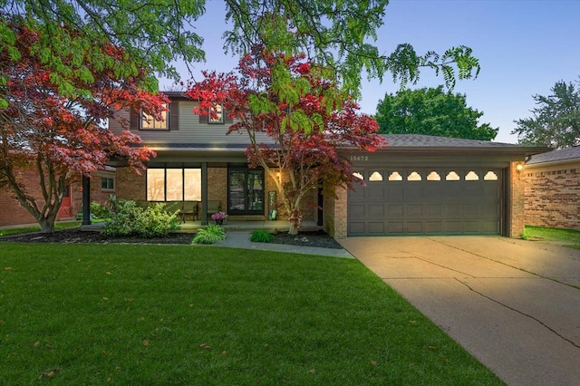 15672 Robert Dr, Macomb, MI 48044 - view of front of property with a garage, a front lawn, driveway, and brick siding
