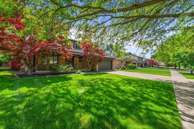 15672 Robert Dr, Macomb, MI 48044 - obstructed view of property with concrete driveway, a garage, a front yard, and covered porch