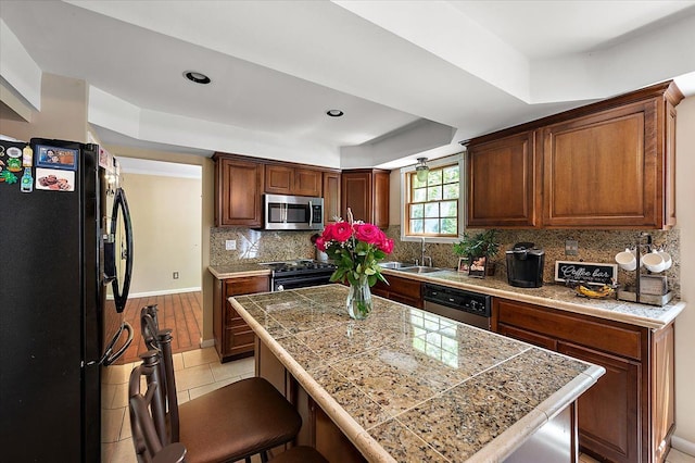 15672 Robert Dr, Macomb, MI 48044 - kitchen with appliances with stainless steel finishes, tile countertops, a sink, a breakfast bar area, and light tile patterned floors