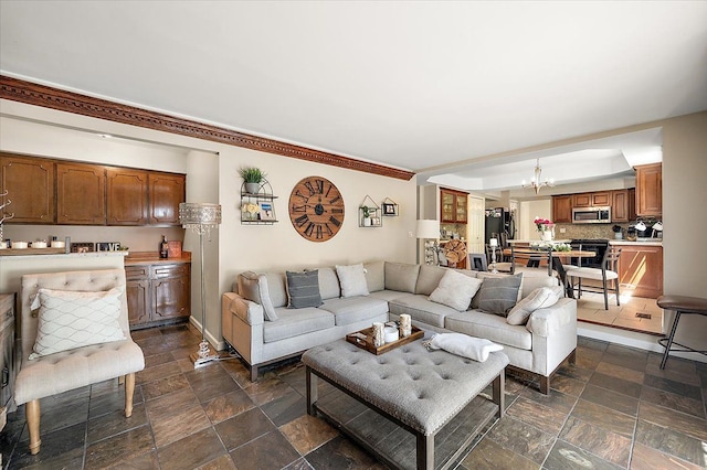 15672 Robert Dr, Macomb, MI 48044 - living room with a chandelier, dark stone finish flooring, and baseboards