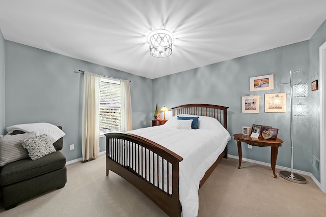bedroom featuring carpet and baseboards