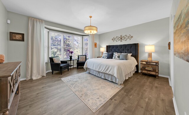 bedroom featuring wood finished floors and baseboards