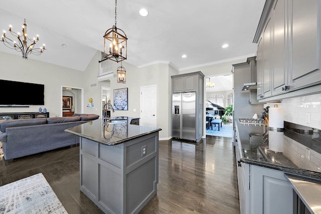 kitchen featuring stainless steel fridge, gray cabinets, a chandelier, a sink, and tasteful backsplash