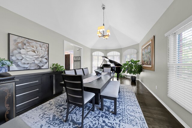 dining space with a chandelier, lofted ceiling, baseboards, and wood finished floors