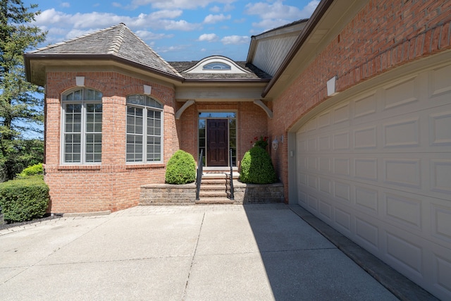 doorway to property featuring brick siding and concrete driveway