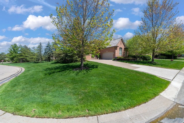 obstructed view of property with concrete driveway, a front lawn, and an attached garage