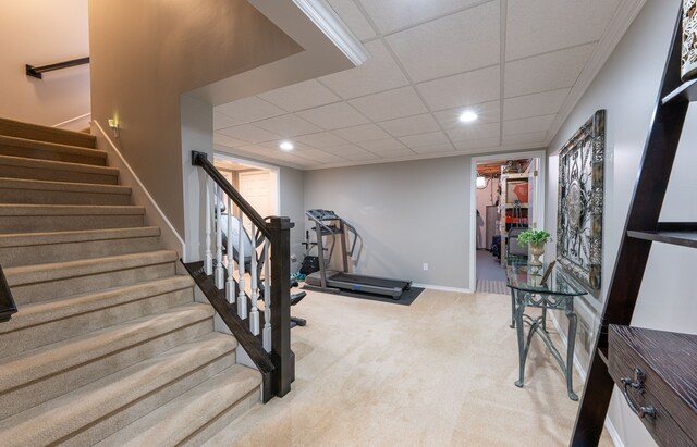 exercise area with carpet floors, recessed lighting, a paneled ceiling, and baseboards