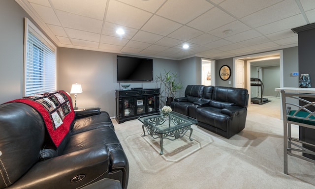 carpeted living room with a drop ceiling