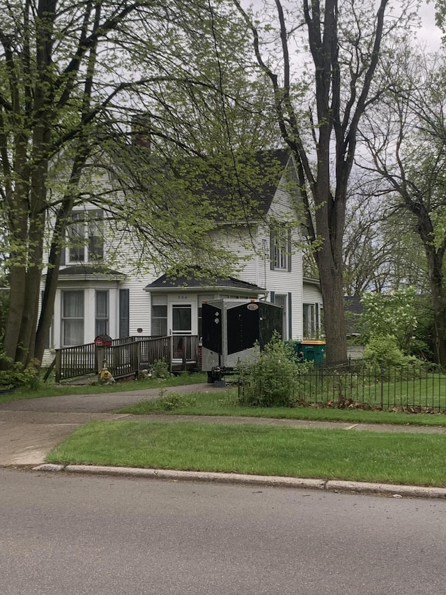 304 E Henry St Unit 18, Saline, MI 48176 - view of front of property featuring a fenced front yard and a chimney