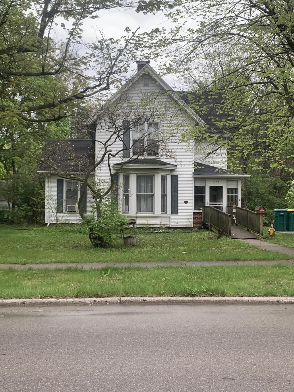 304 E Henry St Unit 18, Saline, MI 48176 - view of front of home with a front yard and a chimney
