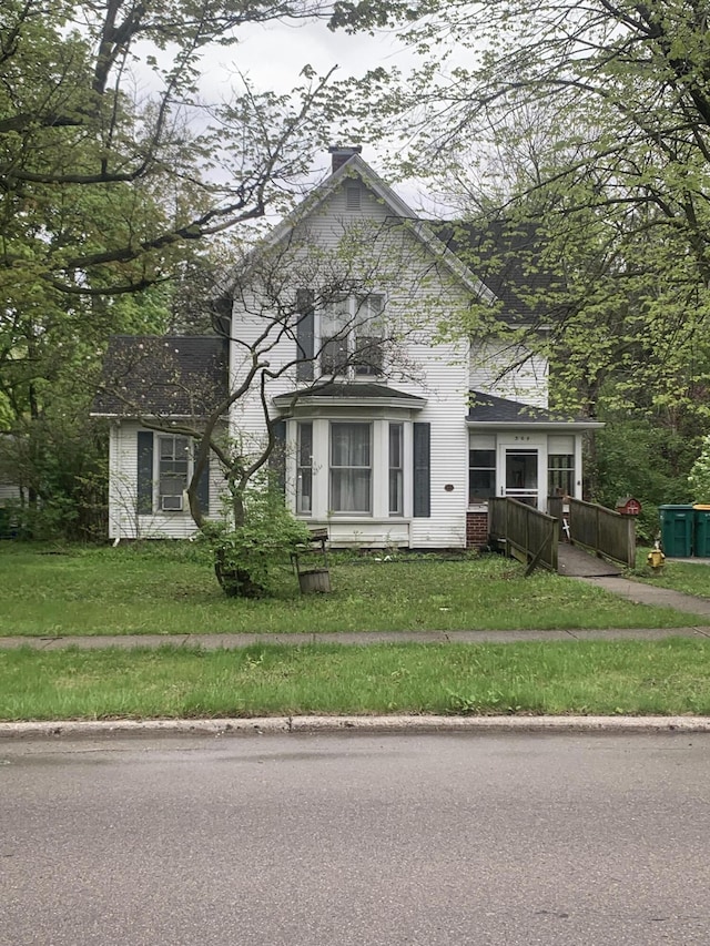 304 E Henry St Unit 18, Saline, MI 48176 - view of front of home with a front yard and a chimney