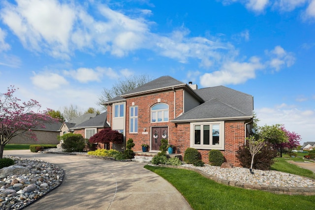47352 Dove Ct, Shelby Twp, MI 48315 - view of front of house with brick siding, a chimney, concrete driveway, and a shingled roof