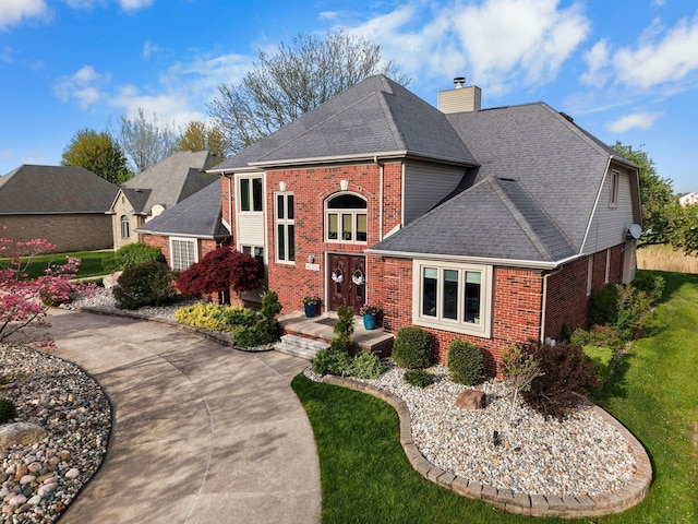 47352 Dove Ct, Shelby Twp, MI 48315 - view of front of house with brick siding, a shingled roof, a chimney, and a front lawn