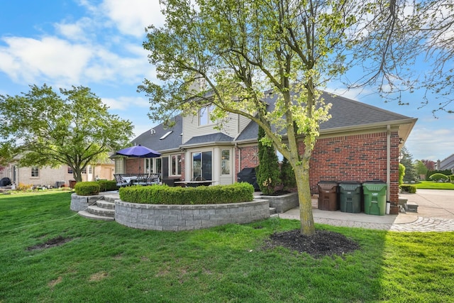 47352 Dove Ct, Shelby Twp, MI 48315 - back of property with a lawn, brick siding, a patio area, and a shingled roof