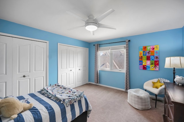 47352 Dove Ct, Shelby Twp, MI 48315 - bedroom with two closets, light colored carpet, baseboards, and a ceiling fan