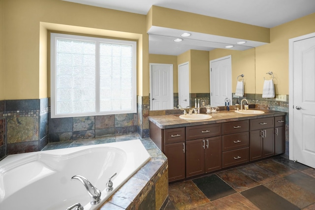 47352 Dove Ct, Shelby Twp, MI 48315 - full bathroom featuring a garden tub, double vanity, stone finish flooring, and recessed lighting