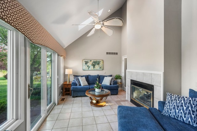 47352 Dove Ct, Shelby Twp, MI 48315 - living area with light tile patterned floors, healthy amount of natural light, high vaulted ceiling, a tiled fireplace, and a ceiling fan