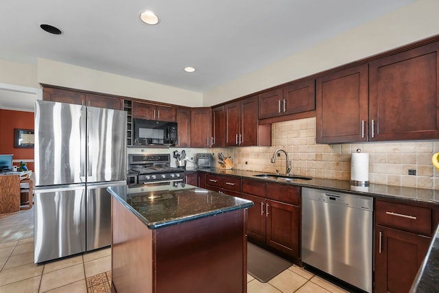 47352 Dove Ct, Shelby Twp, MI 48315 - kitchen with stainless steel appliances, a sink, light tile patterned flooring, dark stone counters, and a kitchen island