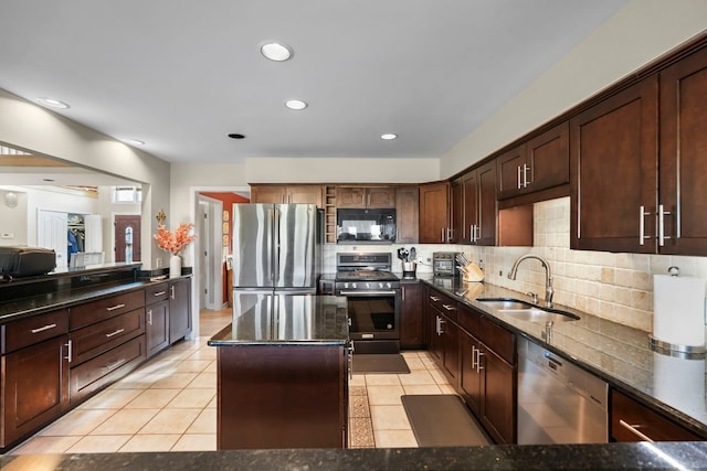 47352 Dove Ct, Shelby Twp, MI 48315 - kitchen with stainless steel appliances, a sink, decorative backsplash, dark stone countertops, and a kitchen island